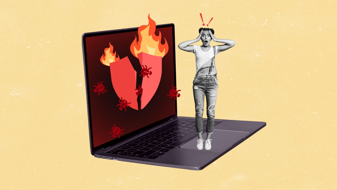 alt=1. A man stands before a laptop displaying a broken heart, symbolizing emotional distress or heartbreak.