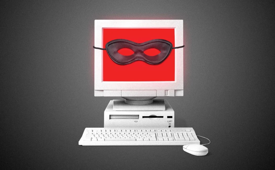 alt=A computer wearing a mask sits beside a keyboard, symbolizing health precautions in a digital workspace.