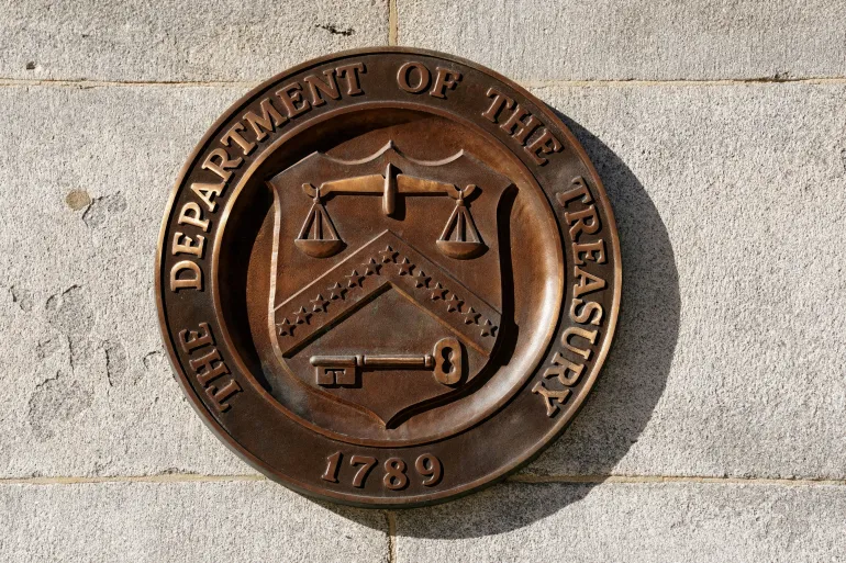 alt=Department of the Treasury building exterior, showcasing its classical architecture and prominent entrance.