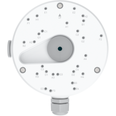 alt=White circular device with numerous labeled buttons and a central dial, likely for controlling settings or functions.