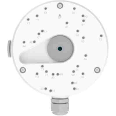 alt=White circular device with numerous labeled buttons and a central dial, likely for controlling settings or functions.