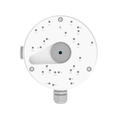 alt=White circular device with numerous labeled buttons and a central dial, likely for controlling settings or functions.