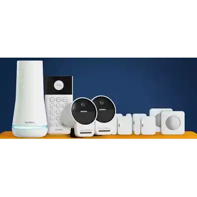 alt=A collection of SimpliSafe home security devices, including cameras, a keypad, and sensors, displayed on an orange surface against a blue background.