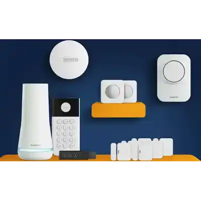 alt=A collection of home security devices, including a base station, keypad, sensors, and a smoke detector, on a vibrant blue and orange background.