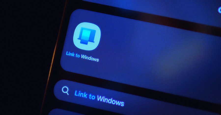 alt=Close-up of a smartphone screen showing the "Link to Windows" app icon and search result in blue light.